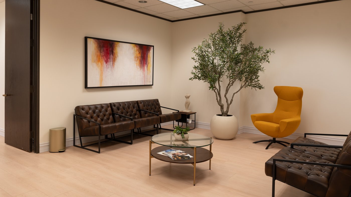 Sereno Medicine waiting lounge in San Antonio — tufted leather seating, original art, and a comfortable environment for concierge internal medicine care